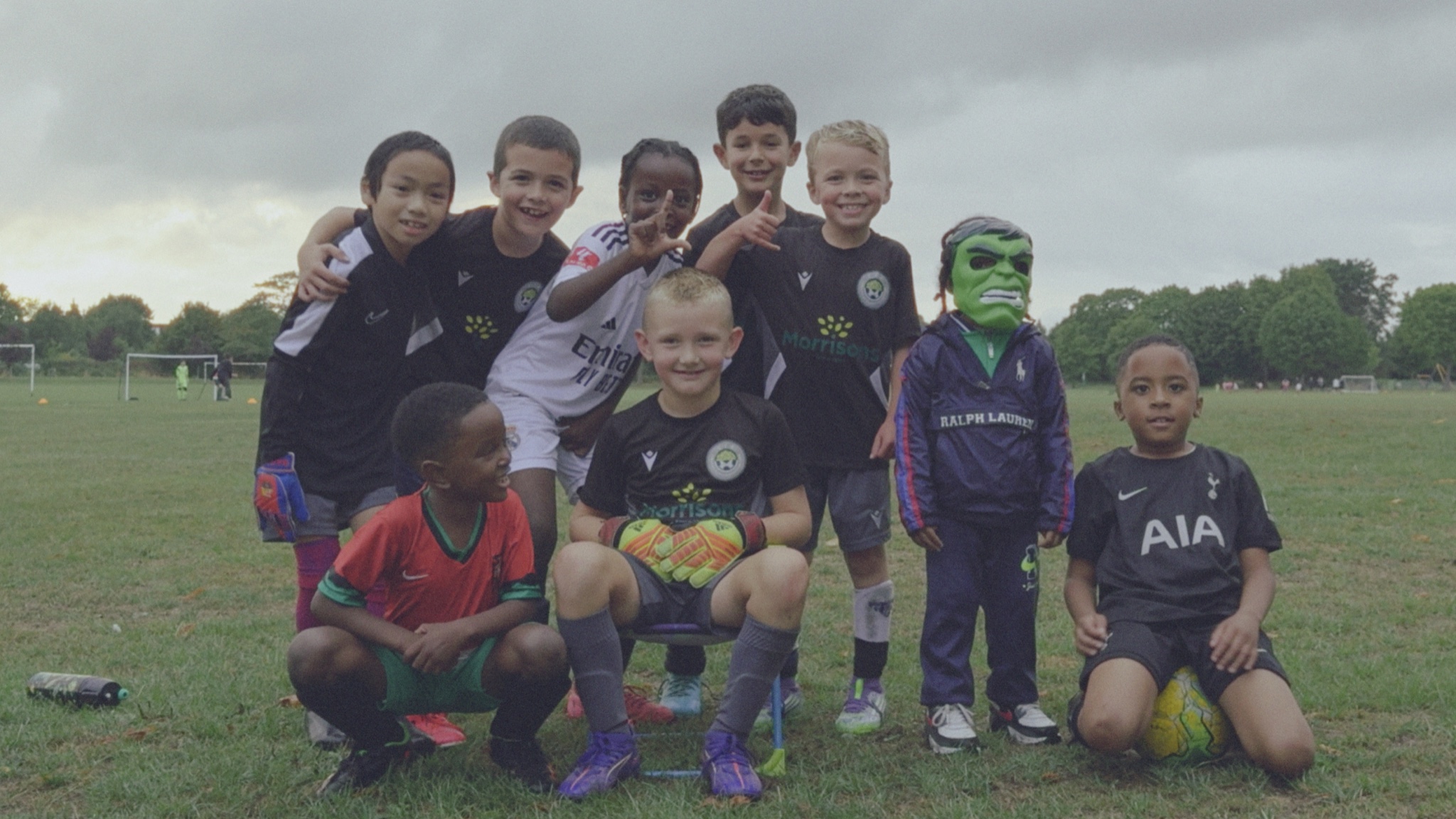 Youth football team posing on a pitch